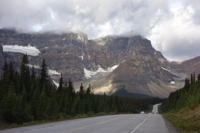 Roaring down the road, kicking up spray