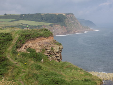 The trail meanders along sea-cliffs overlooking the choppy ocean below.