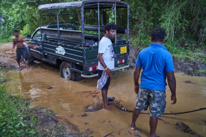 Attempting to pull the jeep out of the mud using jungle vines
